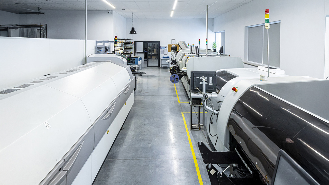 Nowoczesna linia SMT do&nbsp;montażu&nbsp;kontraktowego elektroniki EMS w&nbsp;hali produkcyjnej.